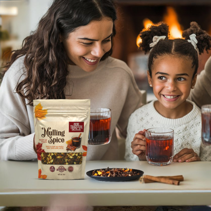 Woman and child enjoying a warm beverage together with a bag of Hulling Spice mix.